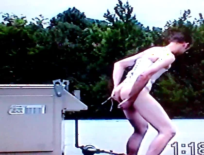 Crossdresser Riding a Giant Dildo on a Roof Top