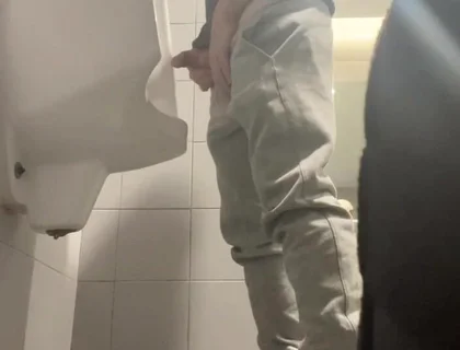 2 Boys in Sneakers Having Fun at Public Toilets' Urinal