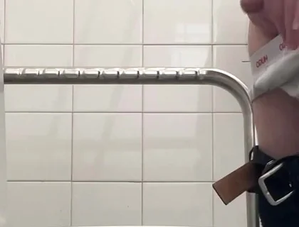 In the Hospital Toilets, a Guy Pisses Into a Cup for a Urine Sample, Then Gets Horny, Jerks-off and Cums