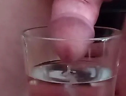Cumming in a glass of hot water