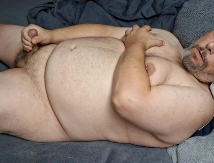 Chubby Guy Lays in Bed and Cums