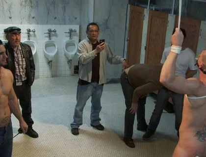 The Wrestler Gets Gang Banged by a Horny Crowd in a Public Restroom for Losing His Match.